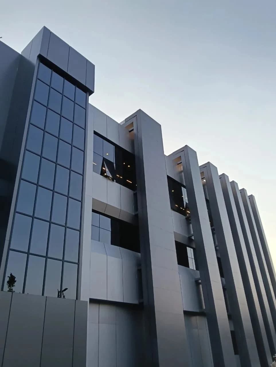 Modern building facade with vertical fins and glazing.